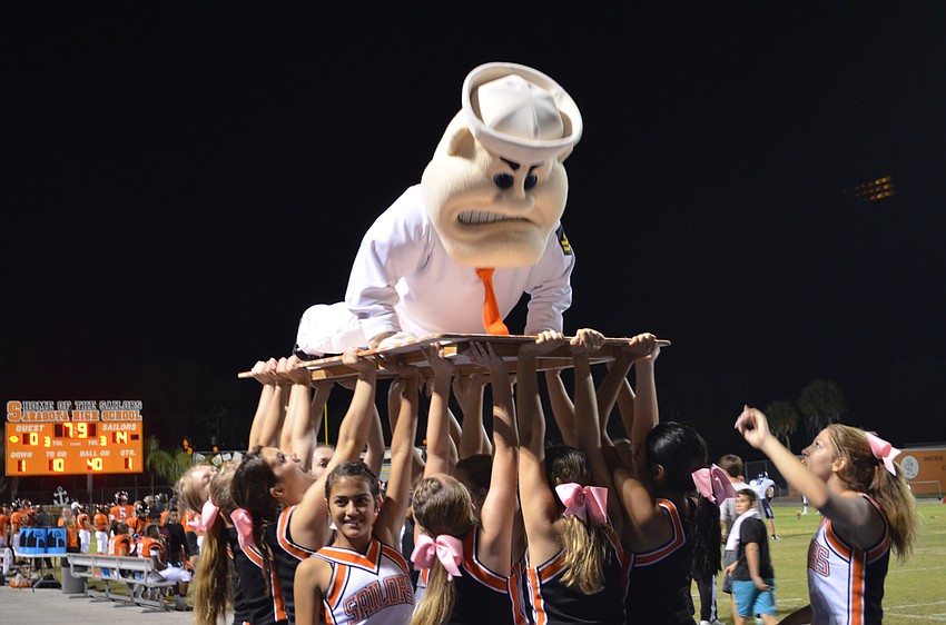 Sailor Sam gets a lift from cheerleaders to complete push ups.