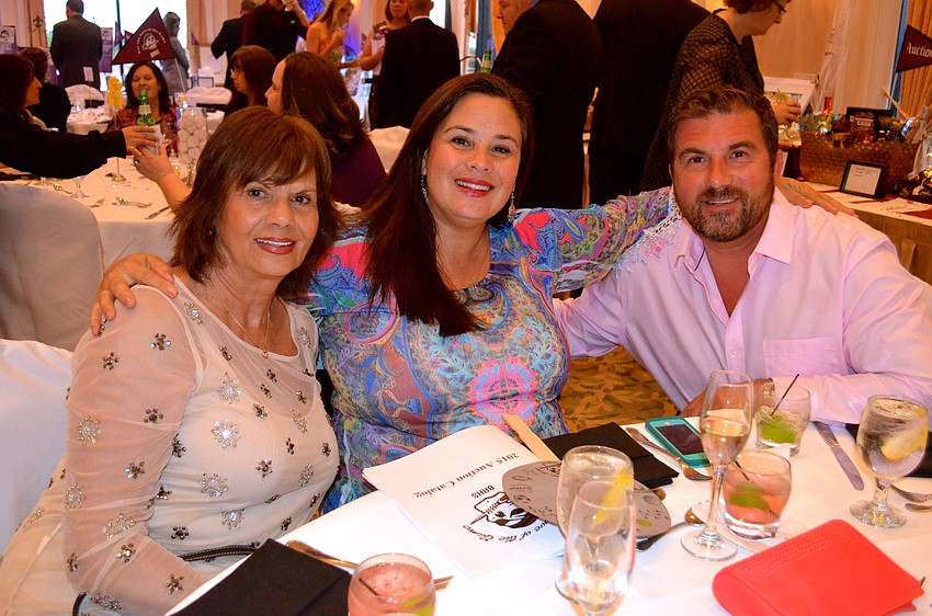 Gerry Findlay and Renee and Blaise Daluise wait for dinner to be served.