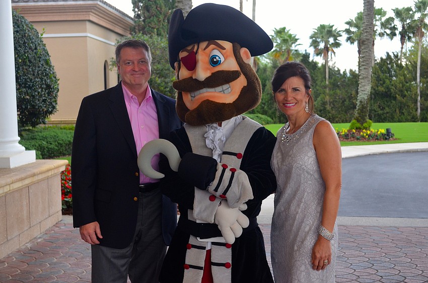 Braden River High's mascot, Capt. Crossbones, poses flanked by Mark and Violetta Huesman.
