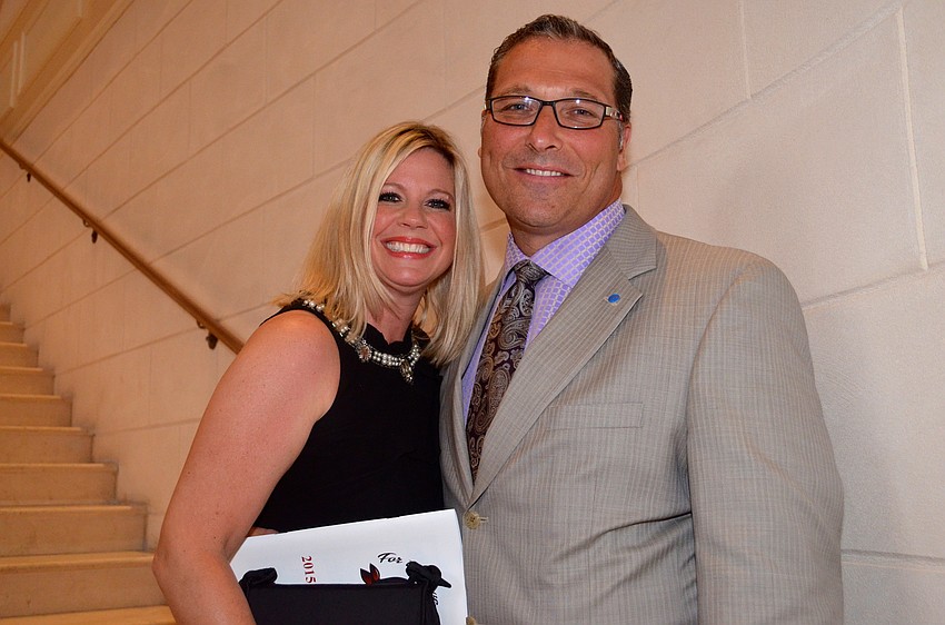 Jennifer and Mark Messner hurry up the stairs to find their seats and their friends.