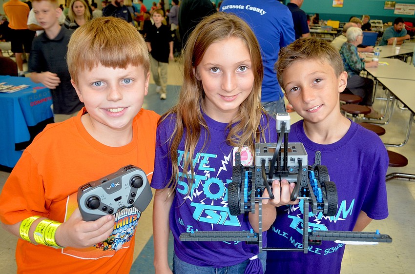 Haile Middle students Aidan Hurley and Miranda and Cody Davis show off their robot.