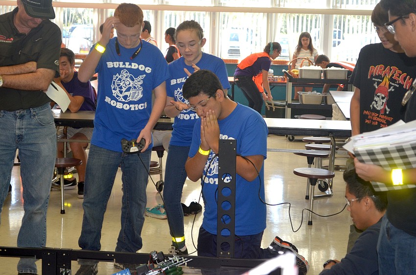 Desoto High students Cody Cassiday, Jessica Kilgore and Romualdo Albiter keep close watch on their robot.