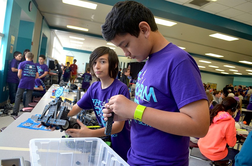 Jordan Sheehan focuses on his Bot12 machine, which he crafted with his partner, Dominic Cozzette, and other teammates.