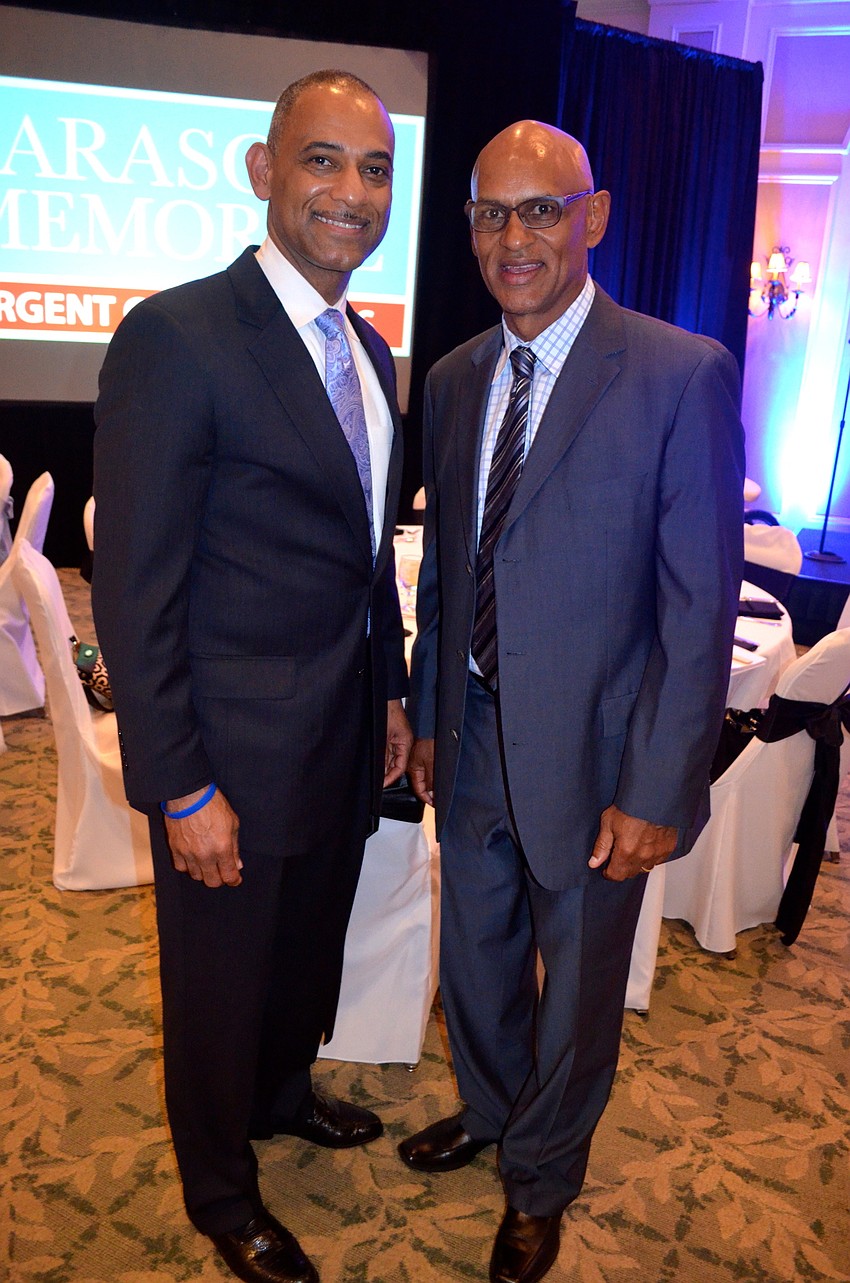 Cousins Skip Vaughan and Phil Bradley wear matching suits and smiles.