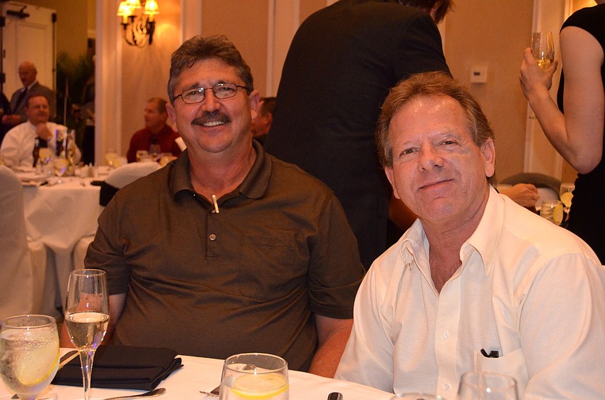 Brad Baker and Gary Merrill chat at their table.