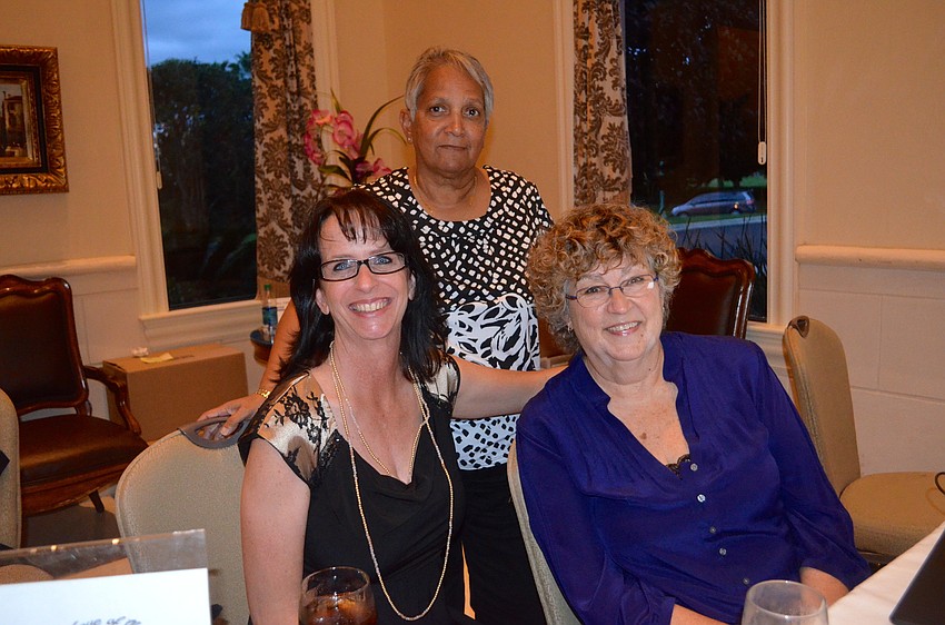Jennifer Elsdon, Evelyn Williams and Celeste Smith welcome attendees at the door.