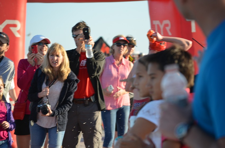 Parents, spouses, siblings, friends and other spectators cheer for the athletes from the sidelines.