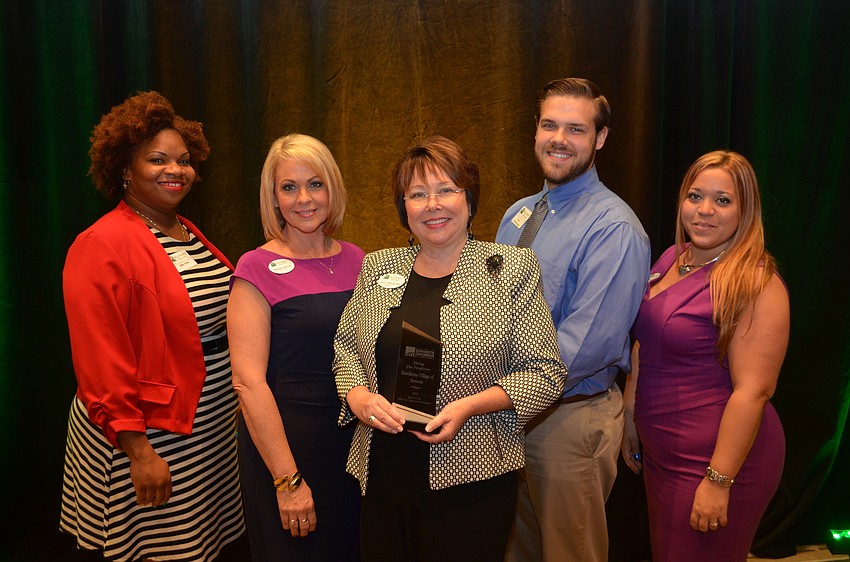 Tramillla Rowe, Margie Ferrino, Laura Haraburda, DJ Haile and Shayla Ladd work at Hawthorne Village of Sarasota, which was honored with the 