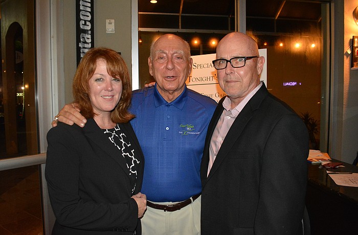 Allison and Gary Fennessy, owners of Main Street Trattoria who hosted Tuesday's pediatric cancer fundraiser, visit with Dick Vitale on Tuesday night.
