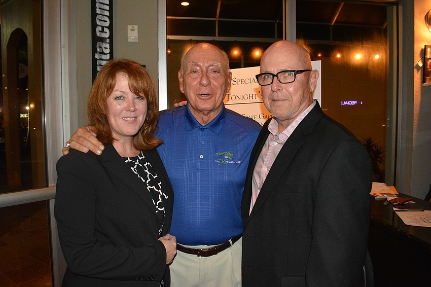 Allison and Gary Fennessy, owners of Main Street Trattoria who hosted Tuesday's pediatric cancer fundraiser, visit with Dick Vitale on Tuesday night.
