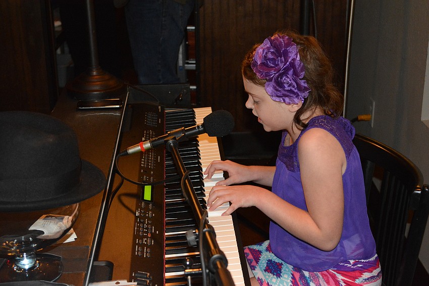 Marissa Peddie, a 10-year-old from Tarpon Springs who is battling leukemia, entered the crowd of more than 100 people on Tuesday at the Dick and Lorraine Vitale fundraiser at Main Street Trattoria.