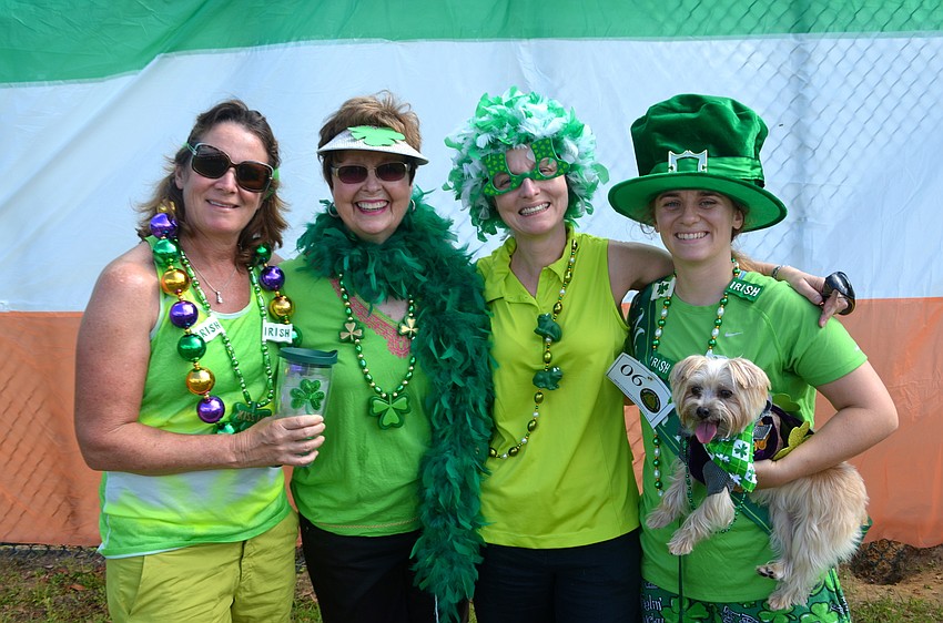Karen Nicholson, Anne and Julie Galla, and Kelly Nicholson pose with their dressed-up dog, Jack Nicholson.