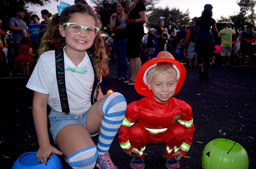 Madison and Jameson Galbraith trick-or-treat side-by-side.
