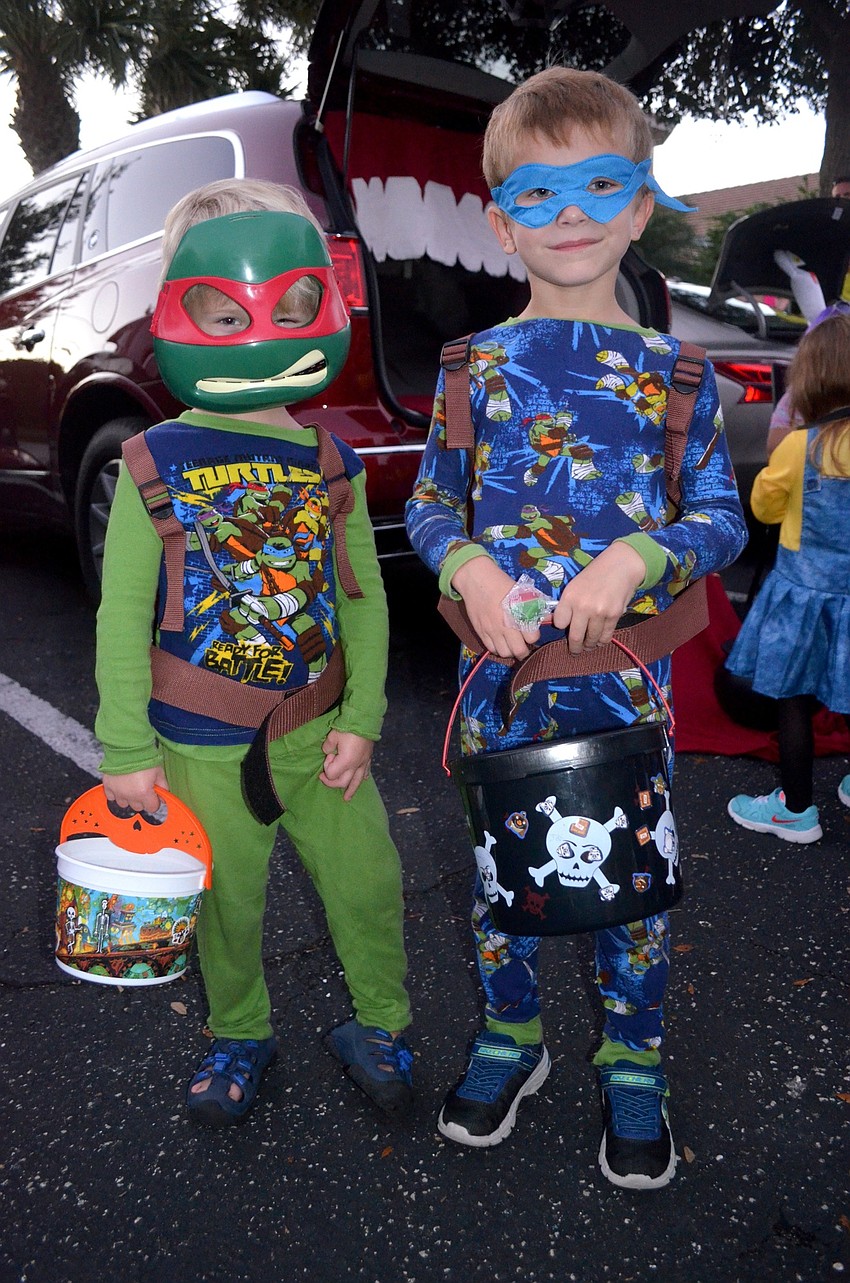 Trey and Jaxon Griffin fill their buckets with candy.