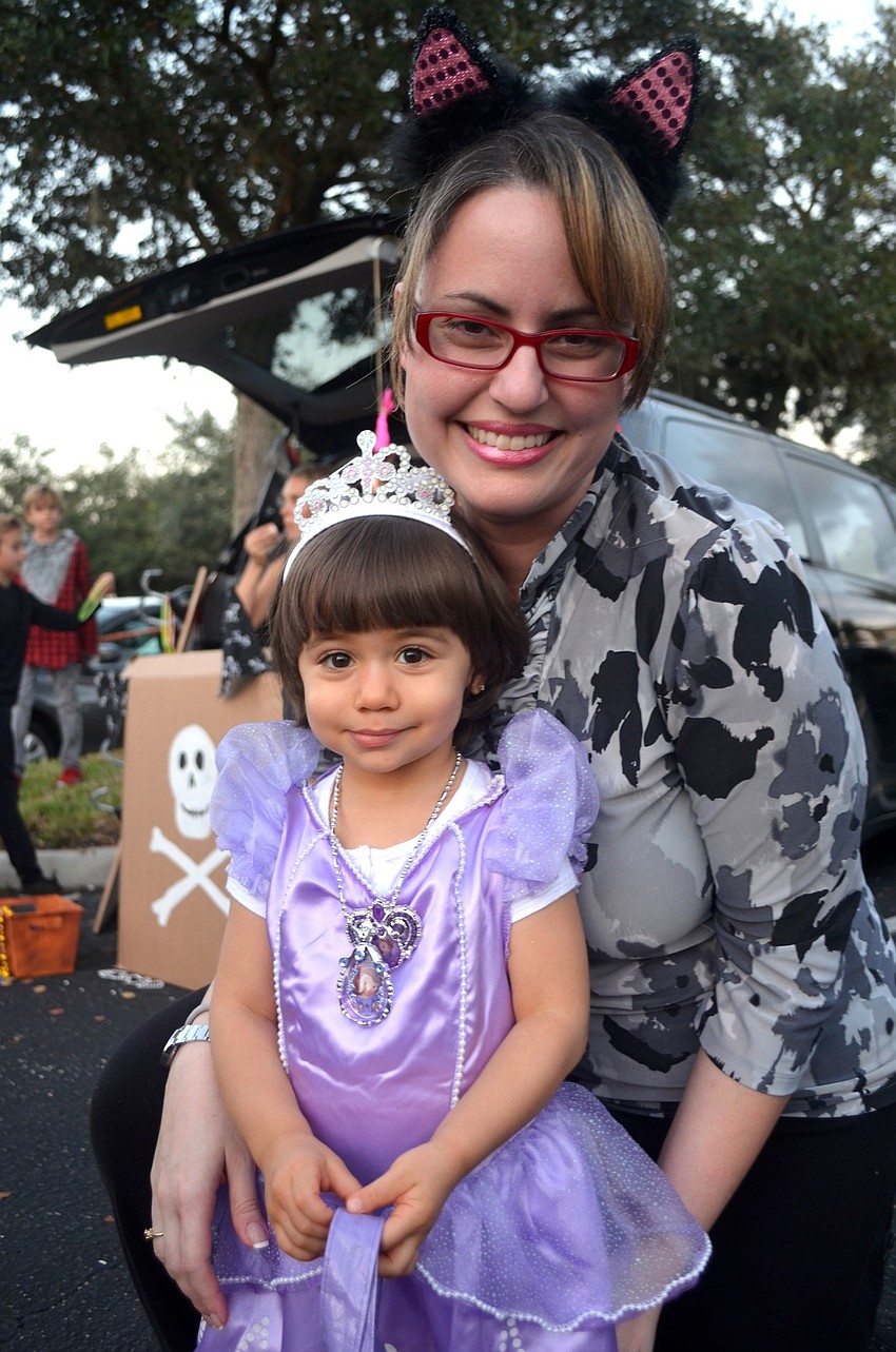Myla Viera and Tatiana Yero take a quick break from trick-or-treating.