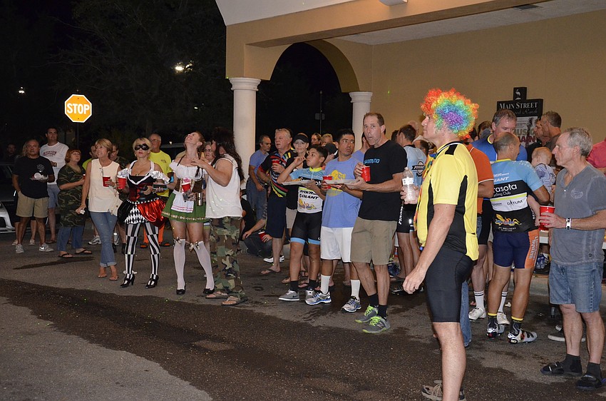 Members of the Village Idiots listen to Paul Troyer, president, give a brief message.