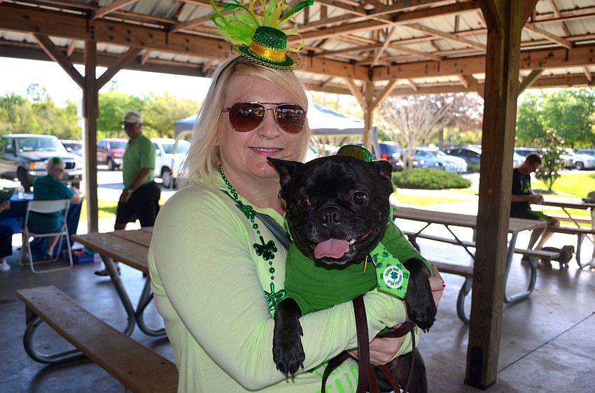 Michelle Blankenship and 3-year-old Brutus show their green pride.