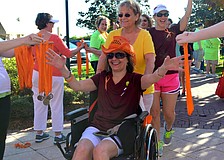 Vicki Reuter walks for Patti Saunders, who she pushed during the walk.