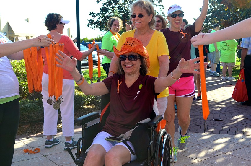 Vicki Reuter walks for Patti Saunders, who she pushed during the walk.