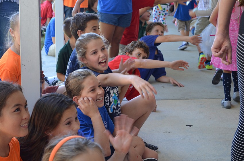 Ashley Balot and Finley Linehan cheer on students as they parade past in costume.