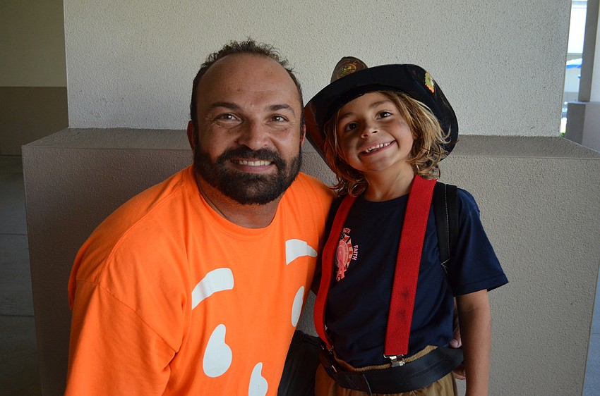James Mattera with his son Dominic who is dressed like a firefighter, which is what his father does.