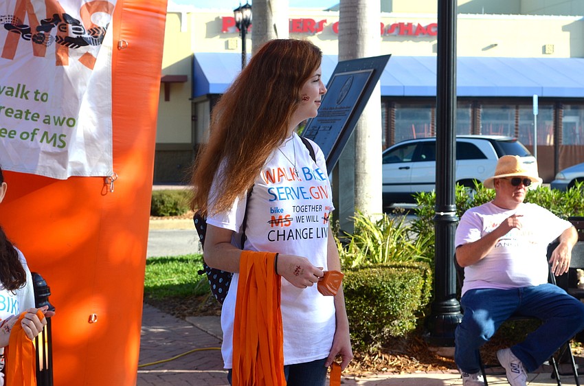 Event volunteer Lauren Cash waits for the next person to cross the finish line.