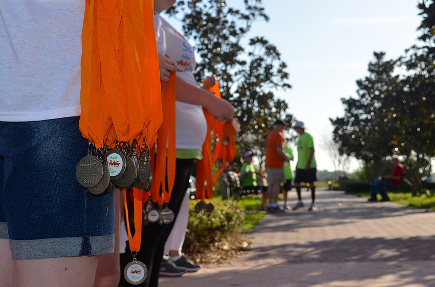 Participants receive medals at the finish line.