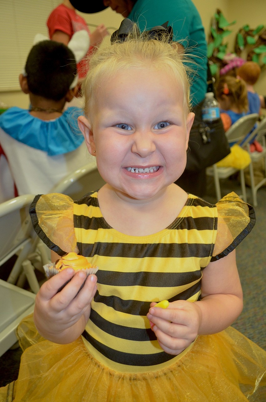 Peyton Frank, of Bradenton, buzzes around while snacking on a cupcake.