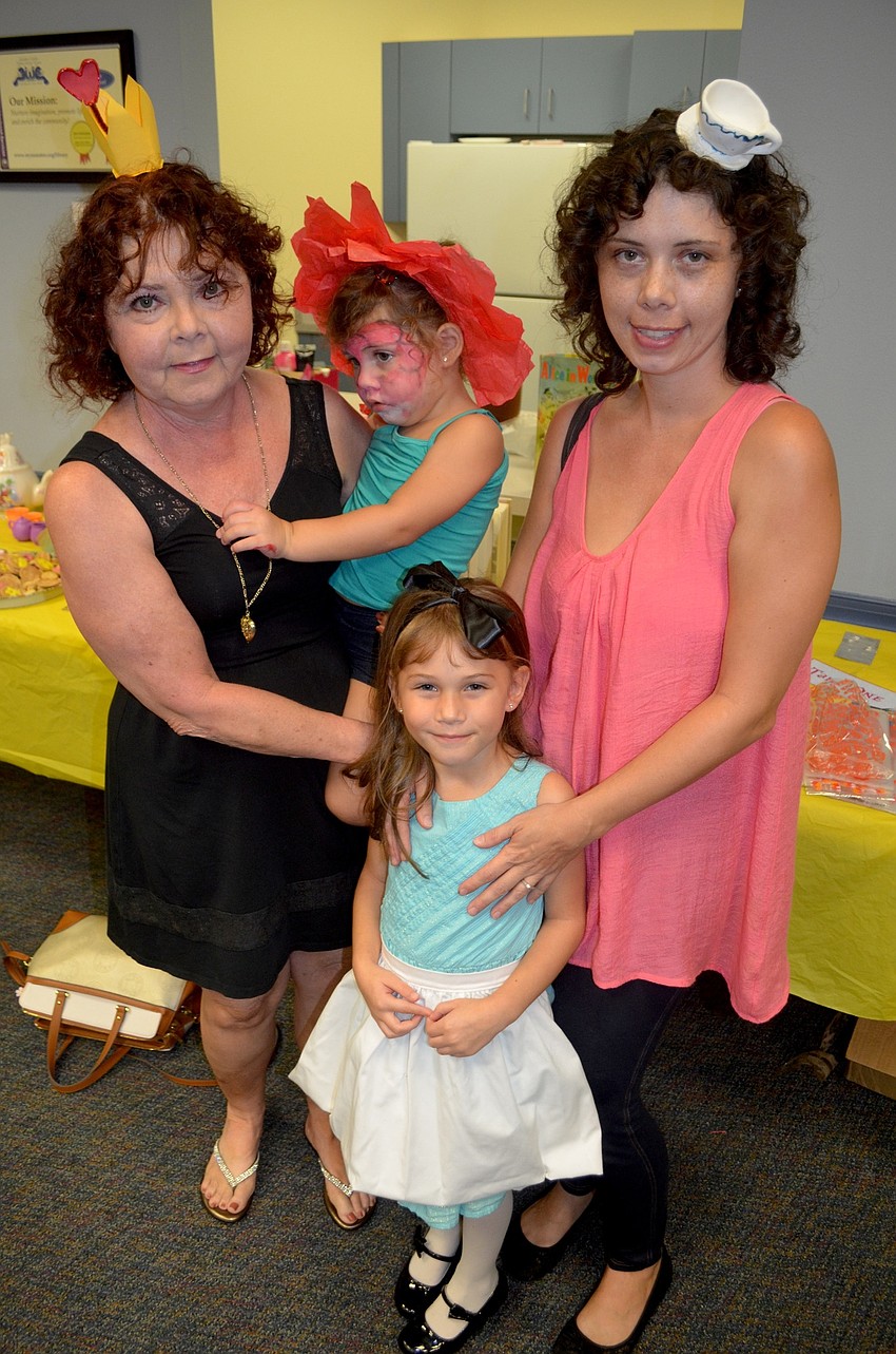 Kelly Hornback and Elizabeth, Alyssa and Charlotte Machado, of Bradenton, get into character.