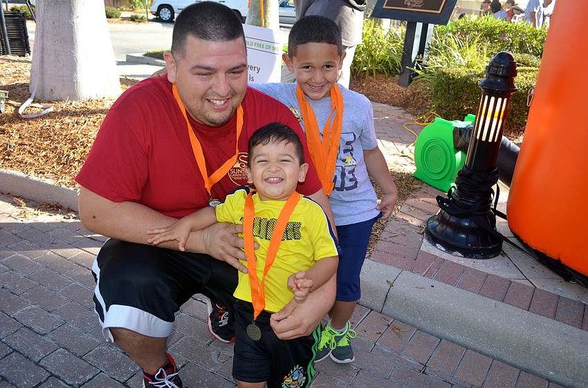 Patrick, Isaiah and Julian Vergara rest after walking the course.