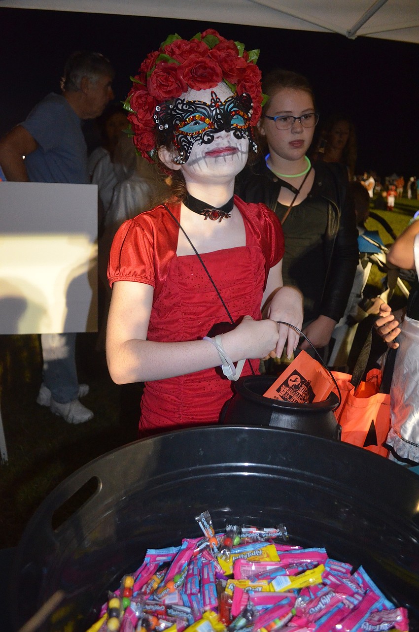 Tessera Mayfair-Drennen, of Lakewood Ranch, finds the candy pot.