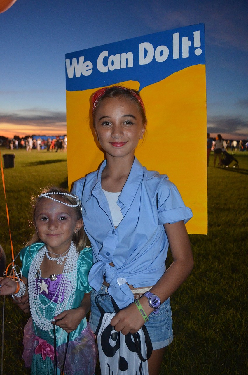 Lenie and Emma Nebra, of Bradenton, trick or treat for candy.