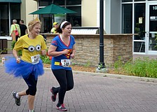 Cathy Duguay and Rina Becker, of Lakewood Ranch, race to the finish line.