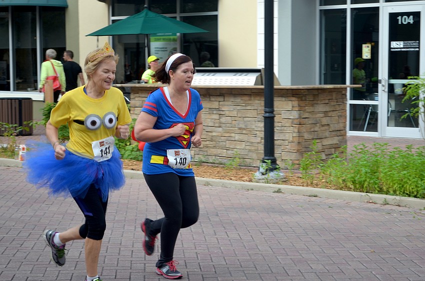 Cathy Duguay and Rina Becker, of Lakewood Ranch, race to the finish line.