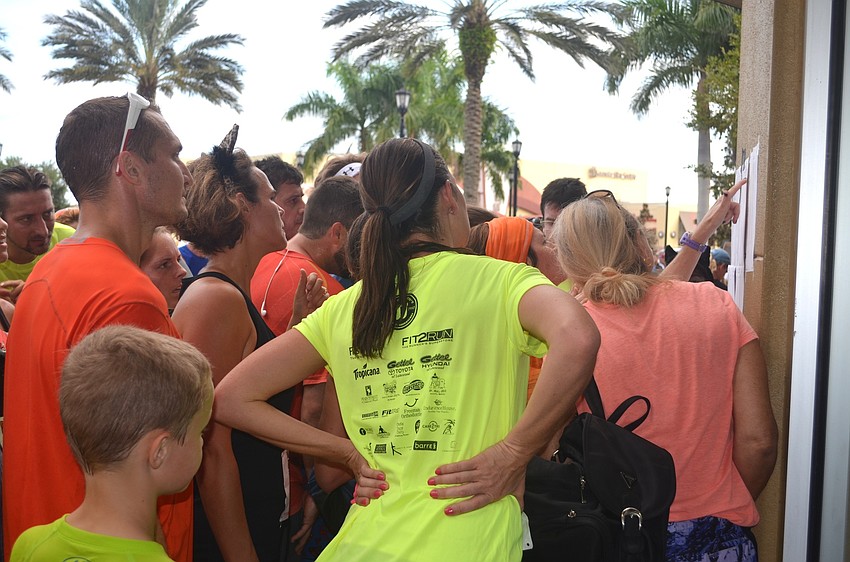 Runners check their times after the race.