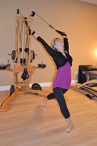 Studio owner Cinde Carroll demonstrating the GYROTONIC EXPANSION SYSTEM Â®, one of the many modalities that she teaches in her studio. It employs spiraling, circular movements with corresponding breath to strengthen and make supple the spine.