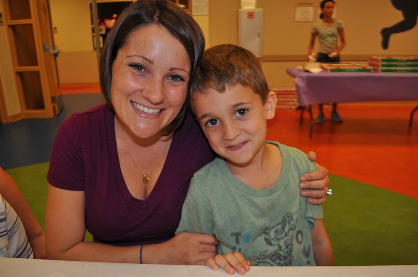 Amanda and Landen Chandler munch on popcorn as they play.