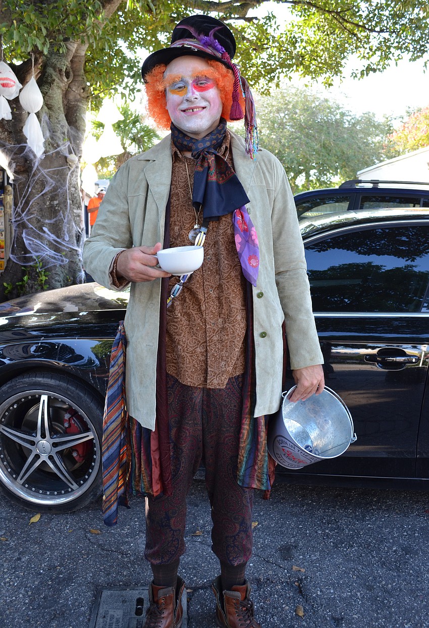 Ryan Mellow helps pass out candy for Siesta Key Oyster Bar dressed as the Mad Hatter.