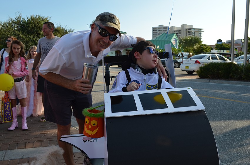 Troy and his son Jake Logan. Troy spent an entire day transforming his son's chair into a space shuttle.