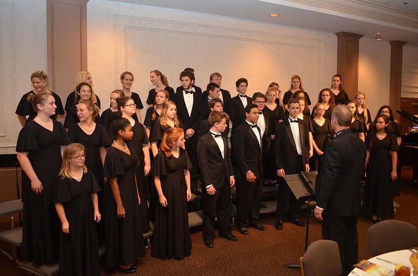 The Sarasota High School chamber choir warms up before its performance.