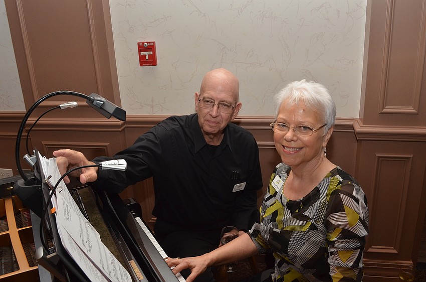 Steve Remis and Nancy Yost Olson preparing to perform accompaniment with the Sarasota High School chamber choir.