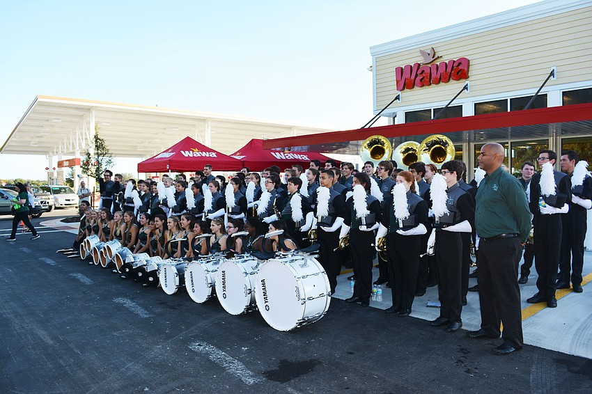 The entire Lakewood Ranch marching band takes time to pose in front of Wawa on Friday morning.
