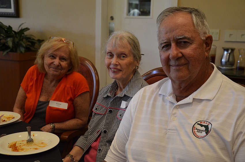 Elaine Sandler and Nancy Page sit with John Grey, the Palm-Aire publications photographer.
