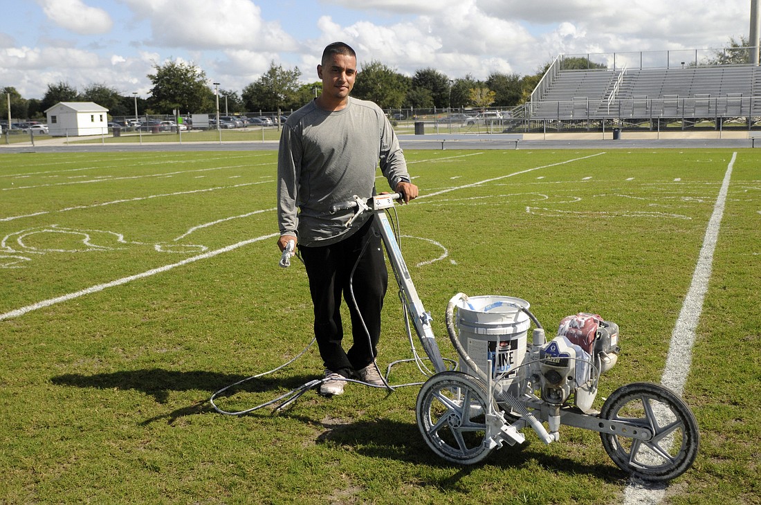 Bradenton resident Carlo Rodriguez has been painting Braden River's football field for the past four years.