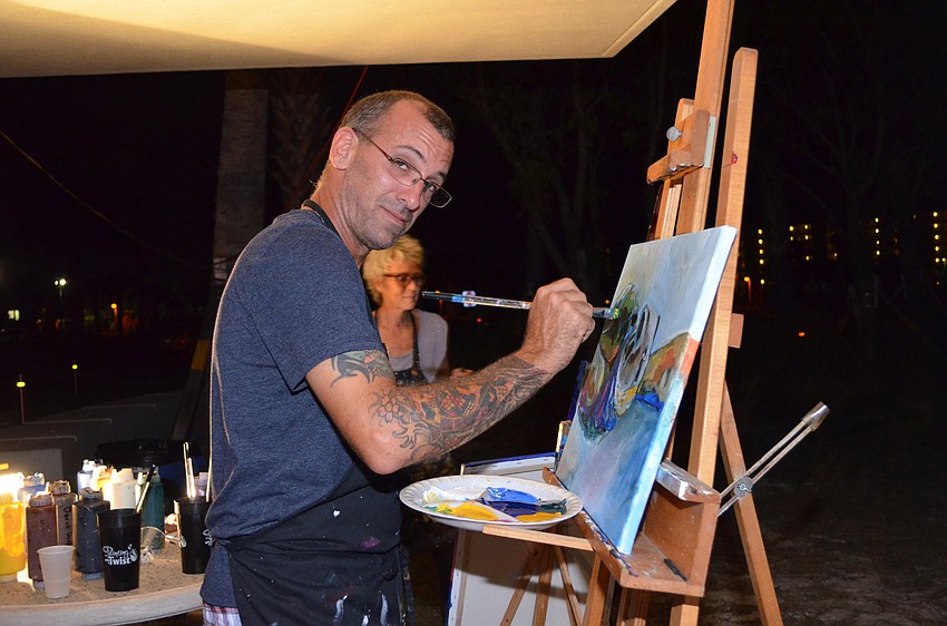 Artist Dante Ferraro does a live painting of a sea turtle.