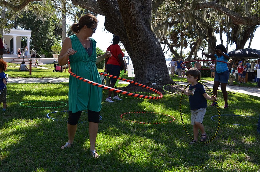 Jessica and Charlie Armstrong hula hoop together.