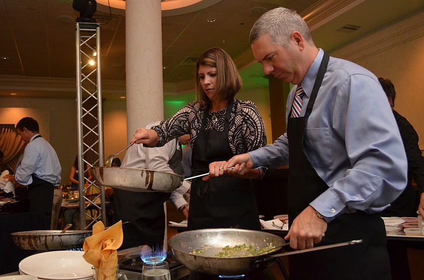 Vicki and Tony Skidmore help prepare Cuban seafood sofrito.
