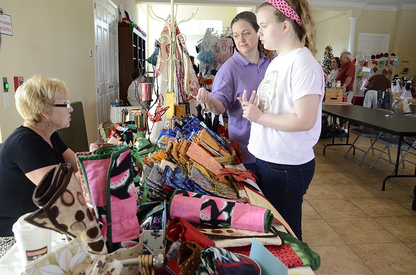 Debbie Bystricky chats with Laura and Hannah Stufflebean at her booth, Perky Pockets.