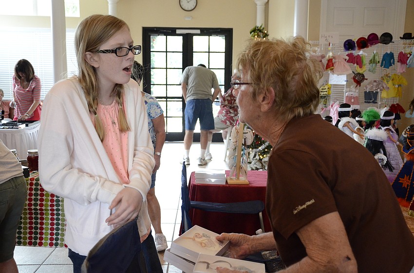 Madison McKee talks with her grandma, Wini, about her sand dollar ornaments.