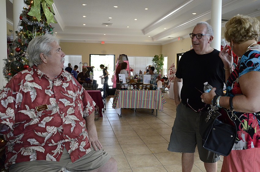 Mike Plaia chats with Stephanie and Alan Gubin at the clubhouse.